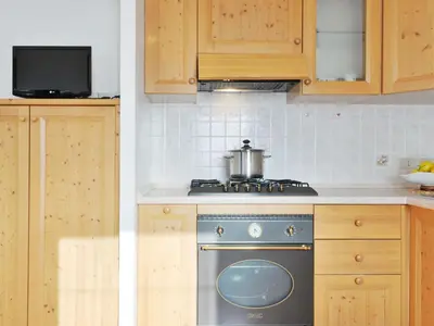 a kitchen and dining room with a table and a window at Apartment Lazzer-2 by Interhome in Campitello