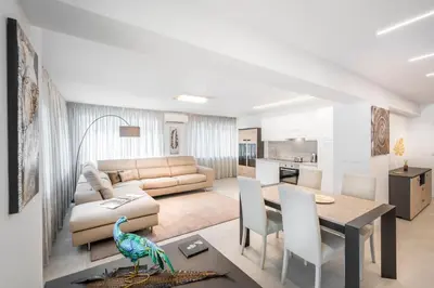 a living room with a couch and a table at Fior Apartments Lofts in Merano
