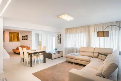 a living room with a couch and a table at Fior Apartments Lofts in Merano