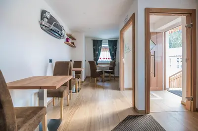 a room with a table and chairs and a dining room at Piccola Cesa B&B in Canazei