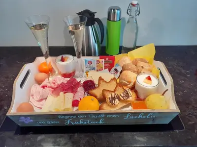 a tray of food with cheese and other foods on a table at Ferienwohnung Haus Reider in Sarntal