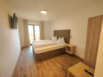 a hotel room with a bed and a window at Schlossberg in San Leonardo in Passiria