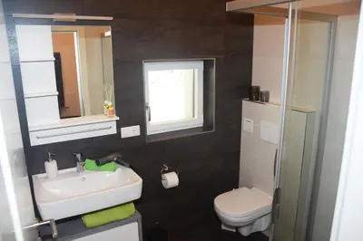 a bathroom with a sink and a toilet at Apartment Zimat in Chienes