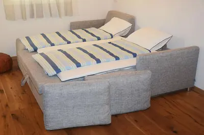 a couch with two pillows on top of it at Apartment Zimat in Chienes
