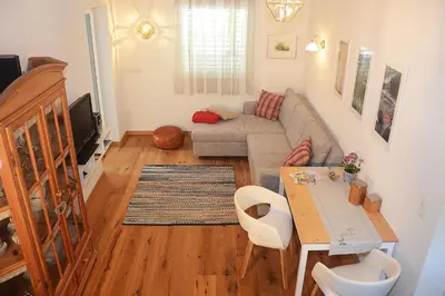 a living room with a couch and a table at Apartment Zimat in Chienes
