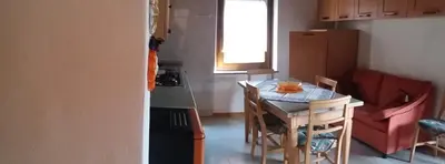 a small kitchen with a small table and a small kitchen with a tableablish at il Nido in Tonadico