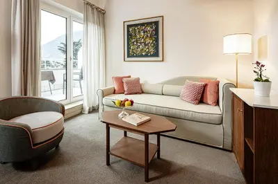 a living room with a couch and a table at Classic Hotel Meranerhof in Merano