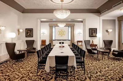 a conference room with a long table and chairs at Classic Hotel Meranerhof in Merano