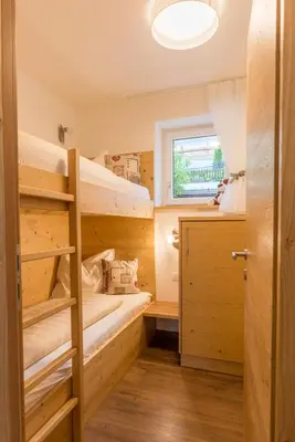 a room with two bunk beds and a window at Residence Apartment Nelkenstein in Schenna
