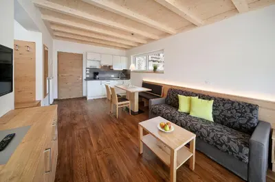 a living room with a couch and a table at Residence Apartment Nelkenstein in Schenna