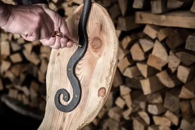 a person holding a snake on a cutting board at Alpenhotel La Montanara in Rocca Pietore