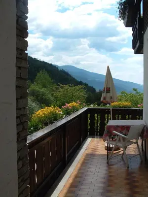 a balcony with a table and a view of the mountains at Gasthof Majestic in Bressanone