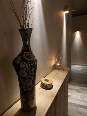 a vase sitting on top of a table with a candle at Park Hotel Faloria in Canazei