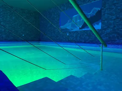 an empty swimming pool with a ping pong net at Park Hotel Faloria in Canazei