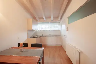 a kitchen with a table and a dining room at Residence Panorama in Brunico