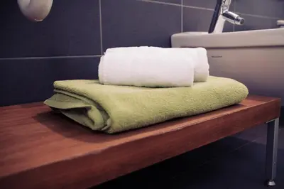 a pile of towels sitting on a table in a bathroom at Residence Panorama in Brunico