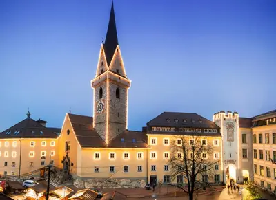 a building with a tower with a clock on it at Residence Panorama in Brunico
