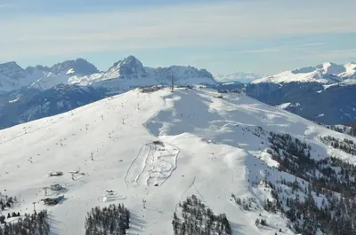 a snow covered mountain with skiers on a ski slope at Residence Panorama in Brunico