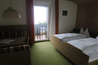 a hotel room with two beds and a window at Residence Scheidnerhof in Aldino