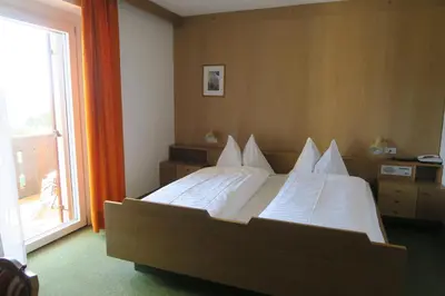 a bedroom with a bed with white sheets and a window at Residence Scheidnerhof in Aldino