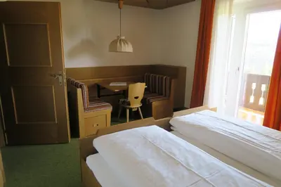 a bedroom with a bed and a table and chairs at Residence Scheidnerhof in Aldino