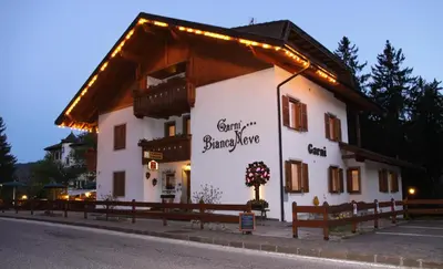 a building with lights on the side of it at Garni Biancaneve Ruffrè-Mendola in Mendola