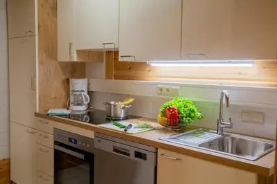 a kitchen with a sink and a counter top at Apartments Schlossblick Naturholz in Vols am Schlern