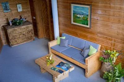 a couch and a coffee table on a porch at Apartments Schlossblick Naturholz in Vols am Schlern