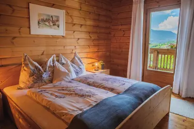 a bed in a room with a window at Apartments Schlossblick Naturholz in Vols am Schlern