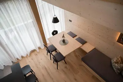 a person sitting in a chair on the balcony of a house at Walderhof Natz in Naz-Sciaves
