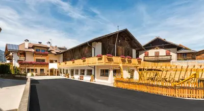 a large building with a balcony on a street at Walderhof Natz in Naz-Sciaves