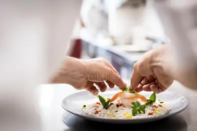 a person is serving a dish of food on a plate at Das Mühlwald - Quality Time Family Resort in Naz-Sciaves