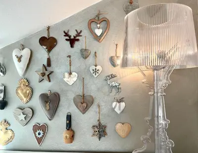 a wall with heart ornaments hanging on a wall at B&B Lavi Ortisei val Gardena in Ortisei