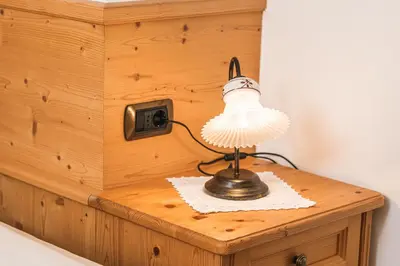 a lamp sitting on top of a wooden box at Residence Cesa Ladina in Ortisei