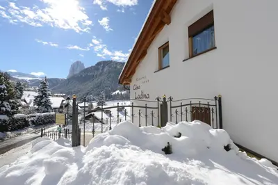 a pile of snow in front of a fence at Residence Cesa Ladina in Ortisei