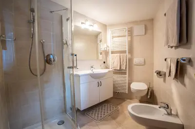 a bathroom with a shower and a sink and a toilet at Residence Cesa Ladina in Ortisei