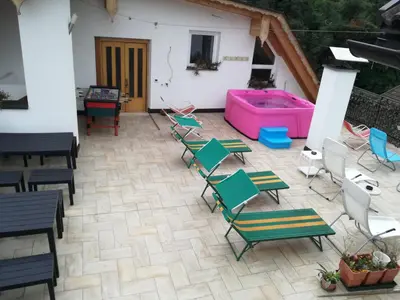 a patio with chairs and a hot tub at Pension Flora in Ora/Auer