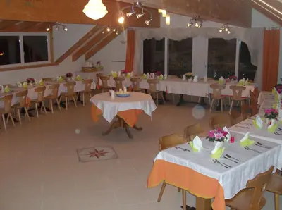 a banquet hall with white tables and chairs and tablesearcher at Pension Flora in Ora/Auer