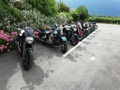 a row of motorcycles parked in a parking lot at Pension Flora in Ora/Auer