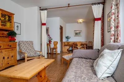a living room with a couch and a table at Residence Weiss in Vigo di Fassa