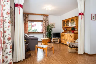a living room with a couch and a table at Residence Weiss in Vigo di Fassa