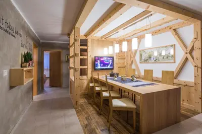 a large bathroom with a sink and a tv at Alpin Apartments Colfosco in Colfosco