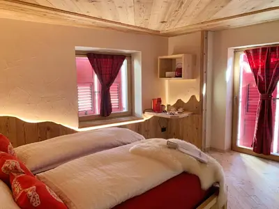 a bedroom with a bed and two windows at Grizzly Haus & Frosch Restaurant - Teritoria in Varena