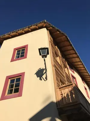 a building with a light on the side of it at Grizzly Haus & Frosch Restaurant - Teritoria in Varena