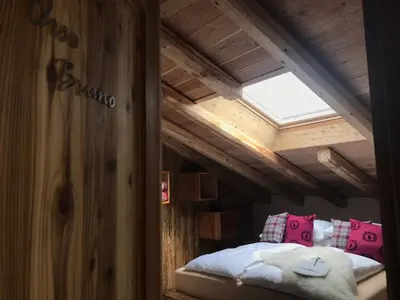 a bedroom with a bed in a wooden ceiling at Grizzly Haus & Frosch Restaurant - Teritoria in Varena