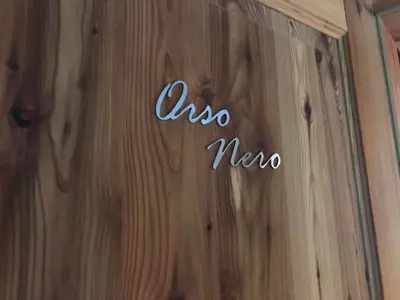 a sign on a wooden wall with the word incoma at Grizzly Haus & Frosch Restaurant - Teritoria in Varena