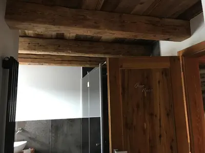 a wooden cabinet with a door in a room at Grizzly Haus & Frosch Restaurant - Teritoria in Varena