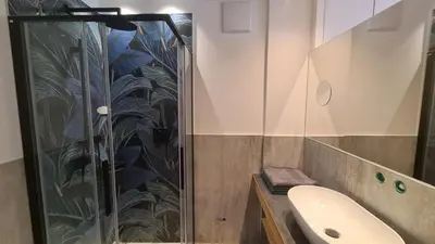 a bathroom with a shower and a sink at Garni Pöhl in Tirolo