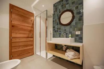 a bathroom with a sink and a mirror at Garnì Aurora Bed and Breakfast in Soraga