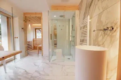 a bathroom with a shower and a sink at Garnì Aurora Bed and Breakfast in Soraga